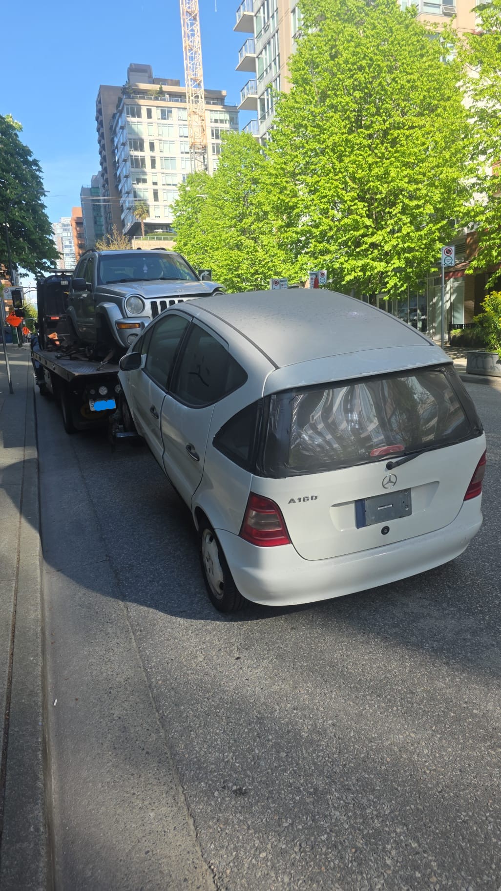 East Van Auto Recyclers flatbed loading a scrap car in Vancouver
